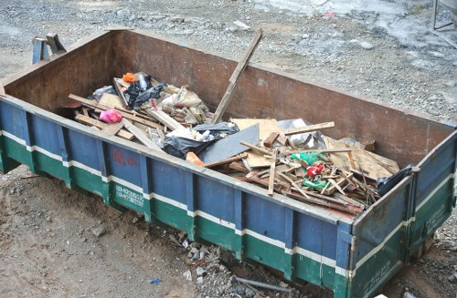 Company vehicle at commercial site with staff preparing for waste collection